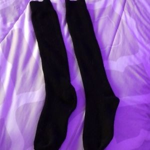 Tall Black socks. (Below knee or right up to)